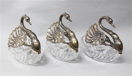 A matched set of three modern repousse silver mounted cut glass sweetmeat dishes modelled as swans, height 6in.